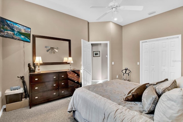 carpeted bedroom featuring ceiling fan and a closet