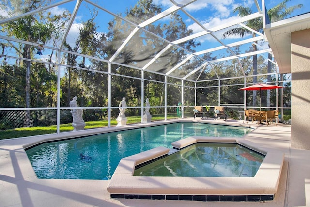 view of pool featuring an in ground hot tub, a patio, and glass enclosure