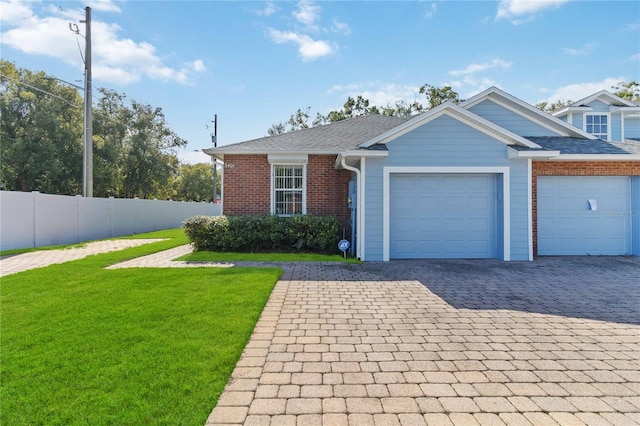 view of front of property with a front yard and a garage