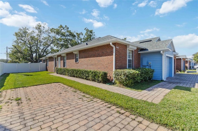 3401 Home Town Ln, Saint Cloud, FL 34769 - view of property exterior with a garage, brick siding, solar panels, and a patio