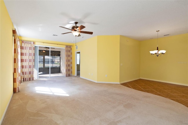 carpeted spare room featuring ceiling fan with notable chandelier