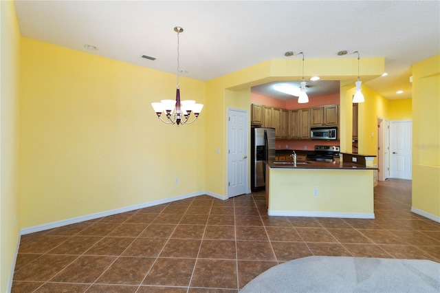 3401 Home Town Ln, Saint Cloud, FL 34769 - kitchen with stainless steel appliances, dark countertops, a chandelier, a sink, and dark tile patterned floors