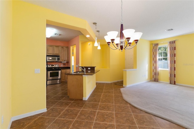 3401 Home Town Ln, Saint Cloud, FL 34769 - kitchen featuring stainless steel appliances, a sink, dark countertops, a chandelier, and open floor plan