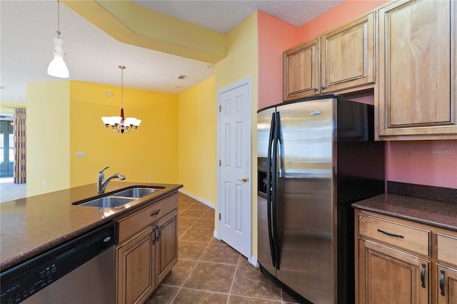 3401 Home Town Ln, Saint Cloud, FL 34769 - kitchen with stainless steel appliances, a sink, dark countertops, a chandelier, and dark tile patterned floors