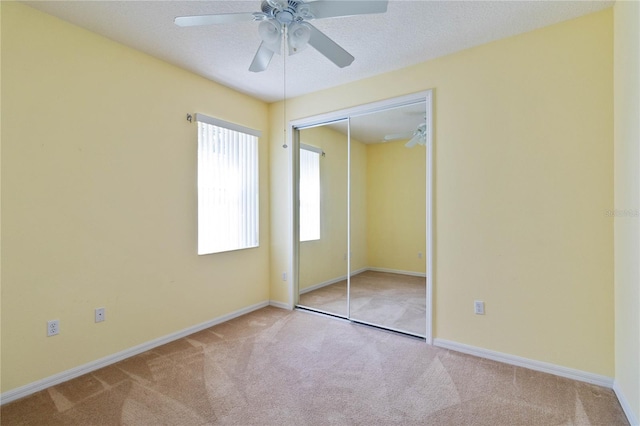 3401 Home Town Ln, Saint Cloud, FL 34769 - unfurnished bedroom with carpet floors, a closet, baseboards, and ceiling fan