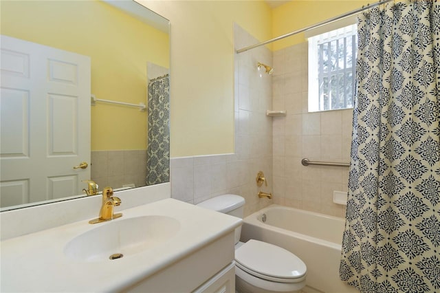 full bathroom with shower / bath combo with shower curtain, vanity, and toilet