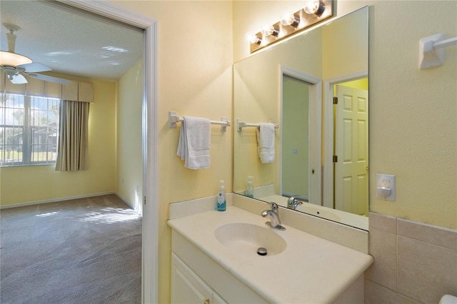 bathroom with tile walls, vanity, a textured ceiling, and ceiling fan