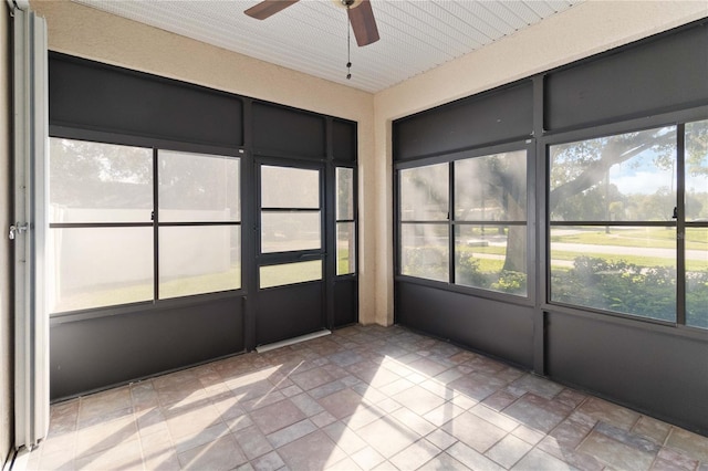 unfurnished sunroom featuring ceiling fan