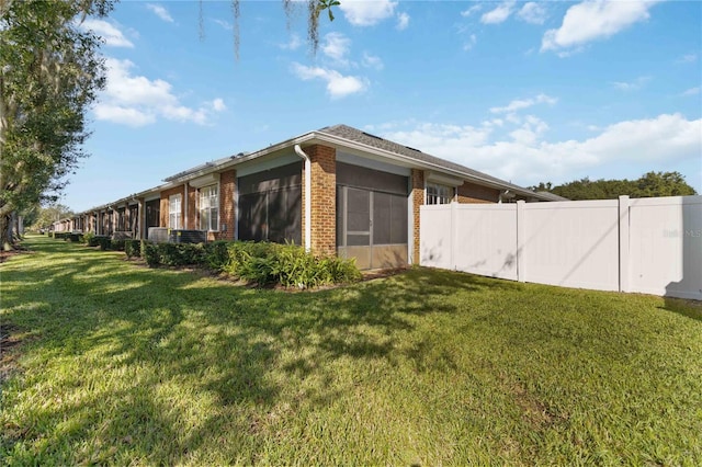 3401 Home Town Ln, Saint Cloud, FL 34769 - view of property exterior with brick siding and a sunroom