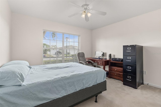 bedroom with ceiling fan and light carpet