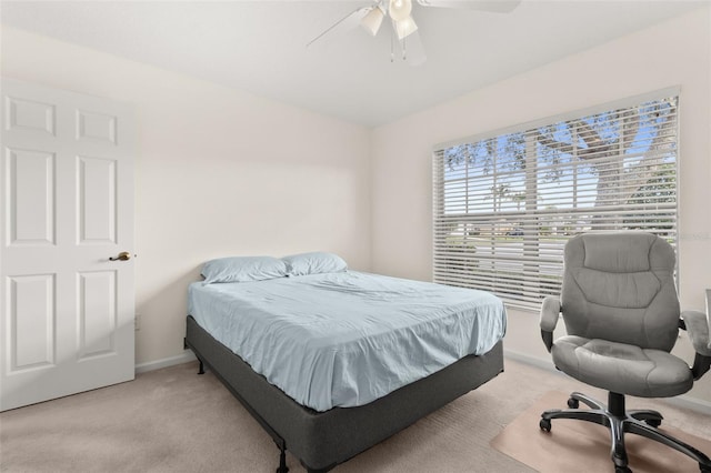 bedroom featuring light carpet and ceiling fan