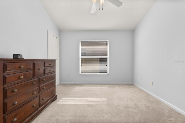 carpeted bedroom with a textured ceiling and ceiling fan