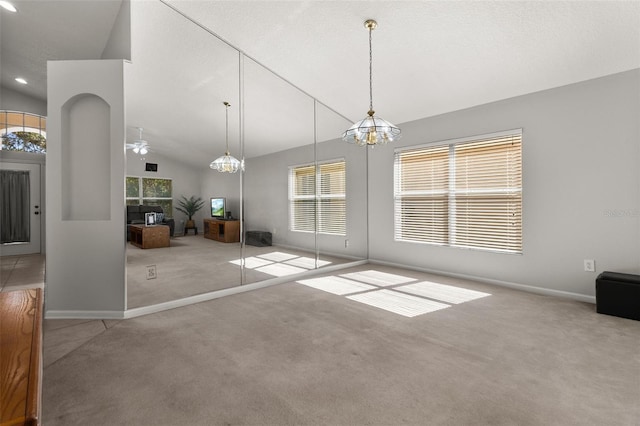 interior space featuring ceiling fan with notable chandelier, high vaulted ceiling, carpet, and a textured ceiling