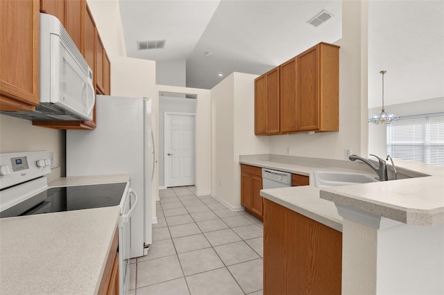 kitchen featuring white appliances, sink, light tile patterned floors, decorative light fixtures, and a notable chandelier