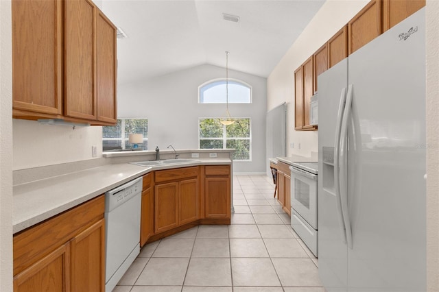 kitchen featuring sink, vaulted ceiling, hanging light fixtures, light tile patterned floors, and white appliances