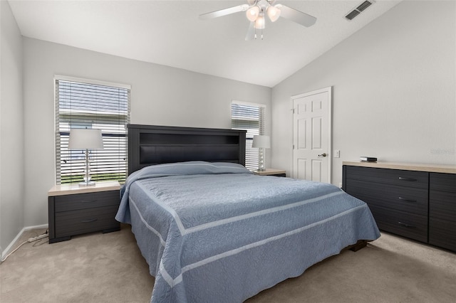 bedroom featuring multiple windows, ceiling fan, light colored carpet, and vaulted ceiling