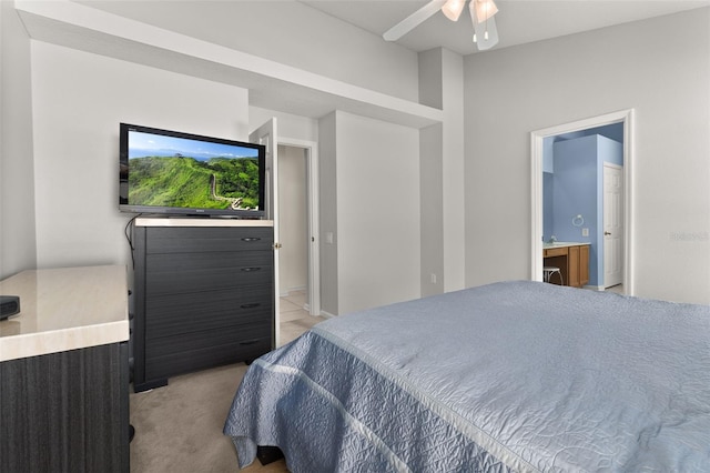 carpeted bedroom with ensuite bath and ceiling fan