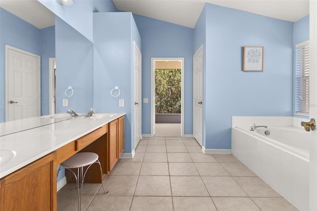 bathroom with tile patterned flooring, vanity, tiled bath, and vaulted ceiling