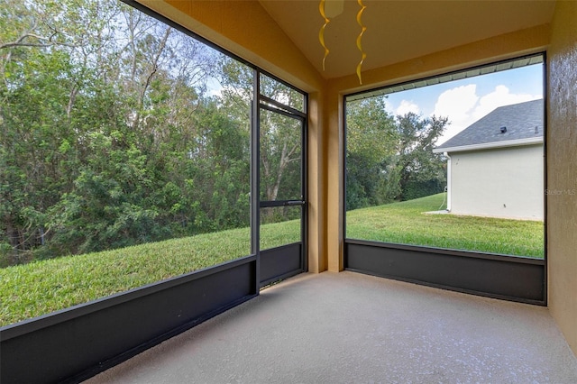 unfurnished sunroom featuring vaulted ceiling