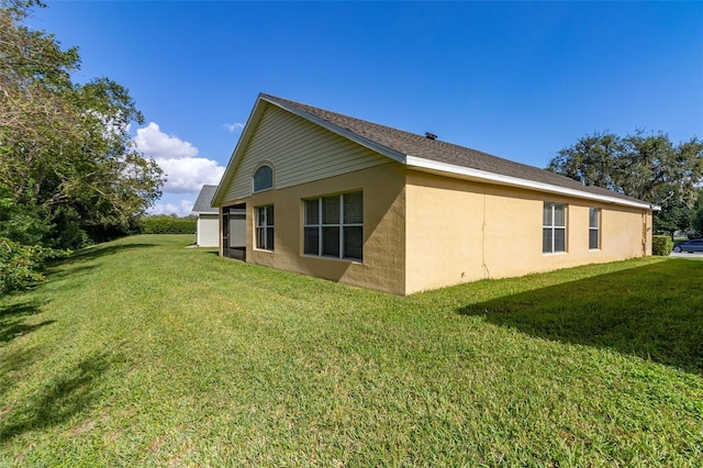 view of side of home with a yard