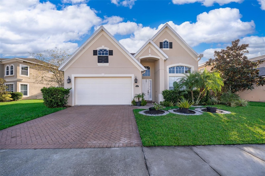 view of front of house featuring a garage and a front lawn