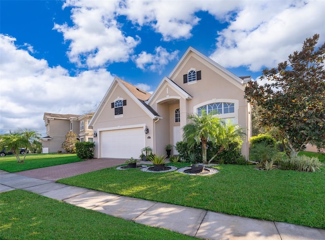 view of front of home with a garage and a front yard