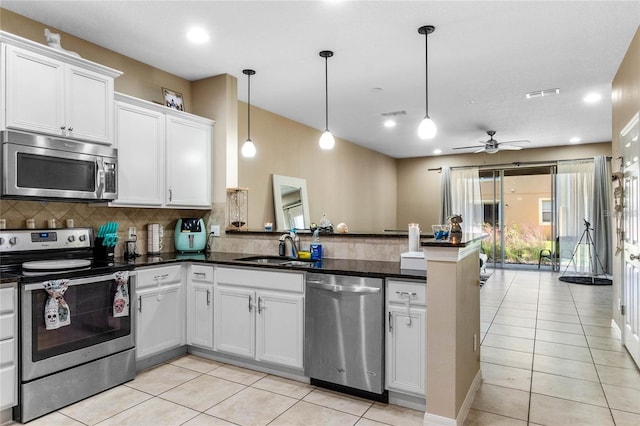 kitchen featuring appliances with stainless steel finishes, tasteful backsplash, ceiling fan, decorative light fixtures, and white cabinets