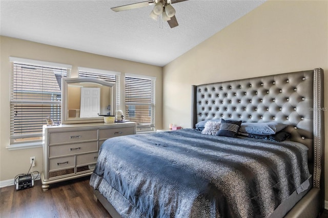 bedroom with a textured ceiling, ceiling fan, dark hardwood / wood-style flooring, and vaulted ceiling