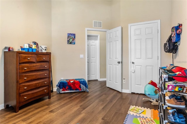 bedroom with dark hardwood / wood-style floors