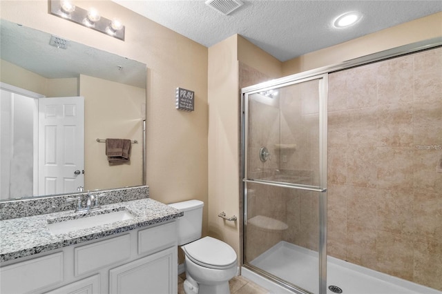 bathroom featuring an enclosed shower, a textured ceiling, and toilet