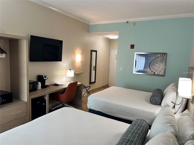 bedroom featuring hardwood / wood-style flooring and ornamental molding