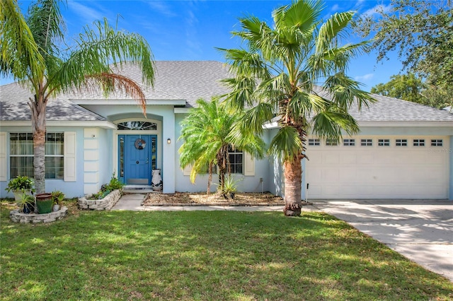 view of front of property with a garage and a front yard