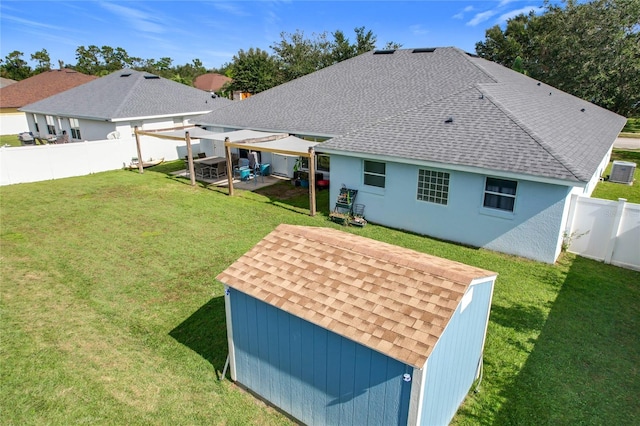 back of property with a patio, a storage shed, and a lawn