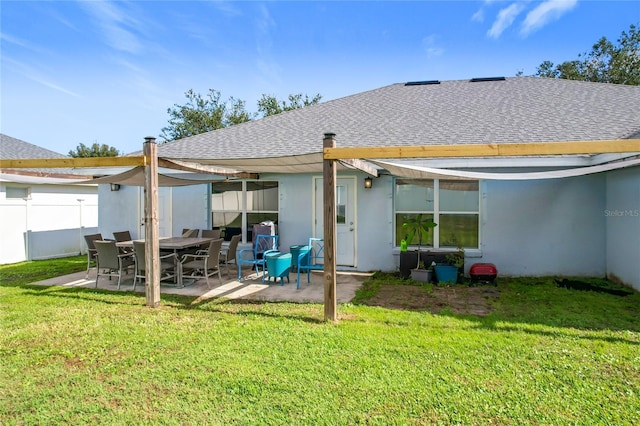 back of property with a patio area and a yard