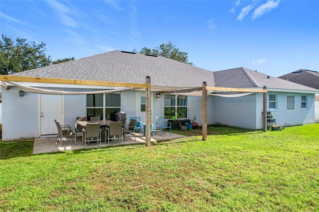 rear view of house with a patio area and a lawn