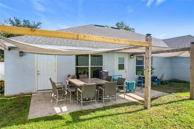 rear view of property with a lawn and a patio area