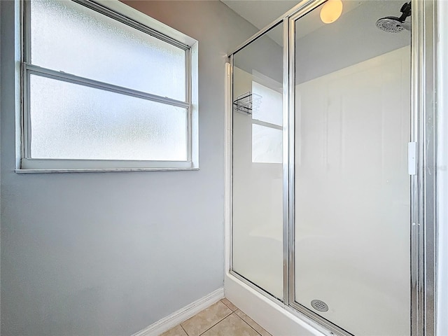 bathroom featuring a shower with door, tile patterned floors, and plenty of natural light