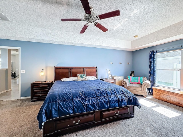 bedroom featuring ceiling fan, carpet floors, and a textured ceiling