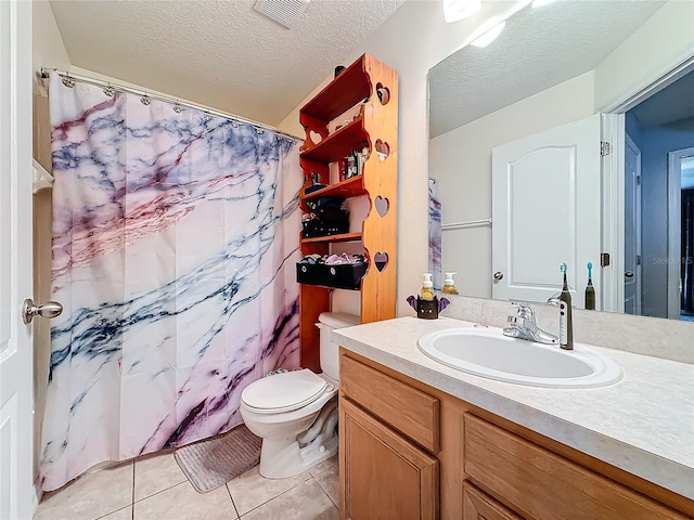 bathroom featuring vanity, tile patterned floors, a shower with shower curtain, toilet, and a textured ceiling