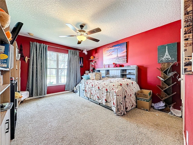 carpeted bedroom featuring a textured ceiling and ceiling fan