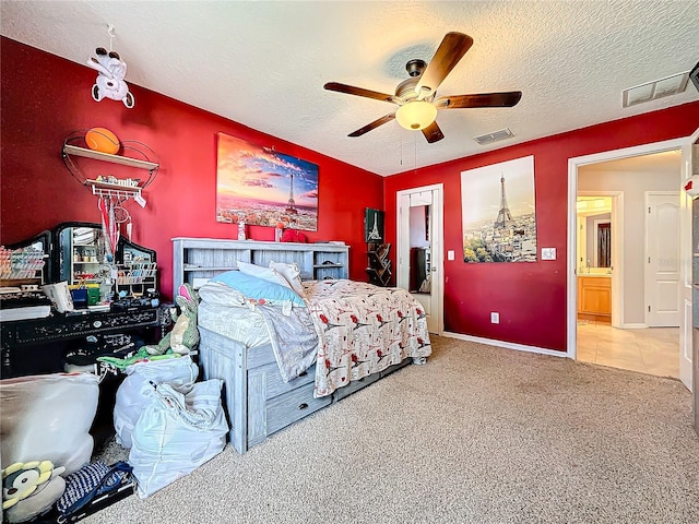 carpeted bedroom featuring ceiling fan and a textured ceiling