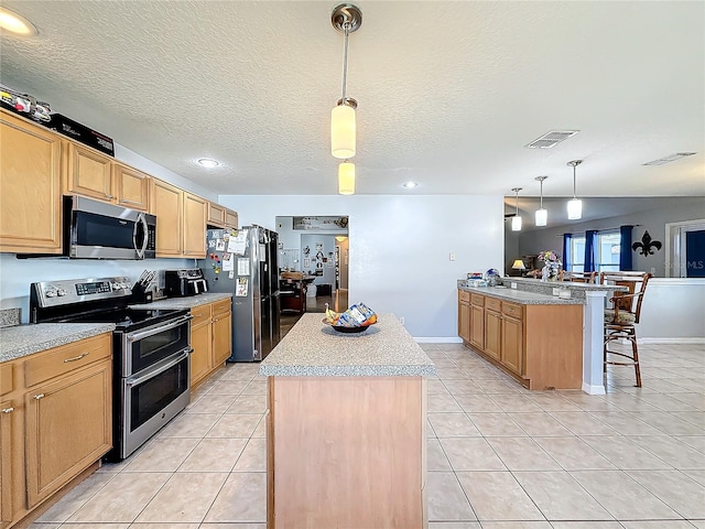 kitchen featuring pendant lighting, a center island, and appliances with stainless steel finishes