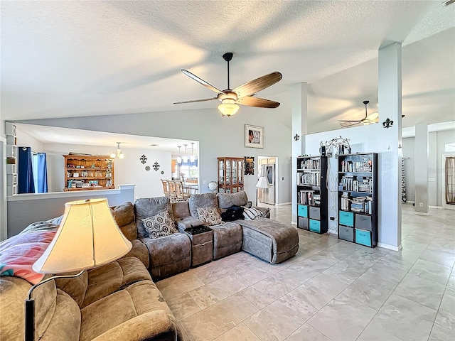 living room featuring a textured ceiling, ceiling fan with notable chandelier, and lofted ceiling