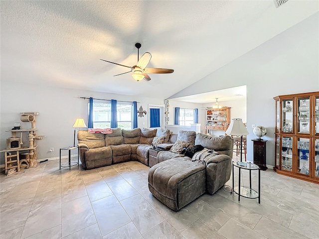 living room with ceiling fan with notable chandelier, lofted ceiling, and a textured ceiling