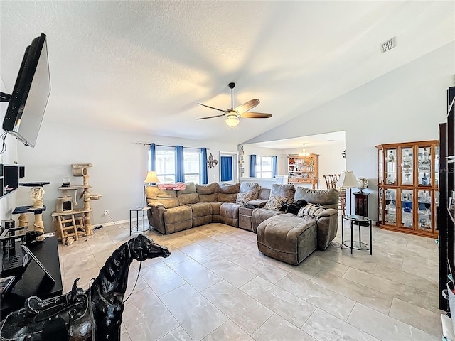 living room featuring ceiling fan, a textured ceiling, and vaulted ceiling