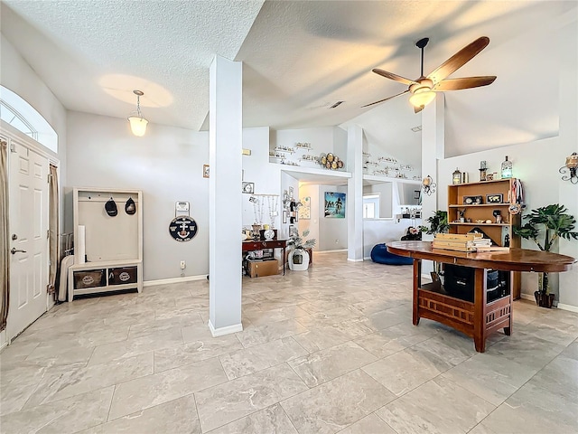 entryway featuring ceiling fan and high vaulted ceiling