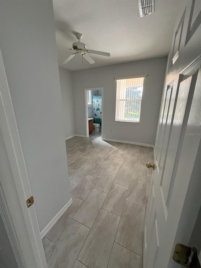 hall featuring a textured ceiling