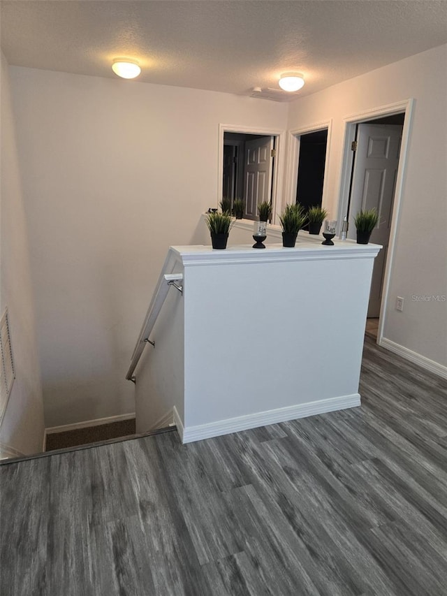 interior space featuring hardwood / wood-style flooring and a textured ceiling