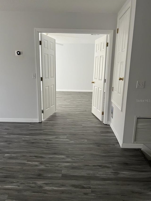 corridor featuring dark hardwood / wood-style flooring