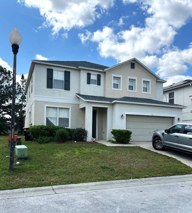 front of property featuring a front yard and a garage